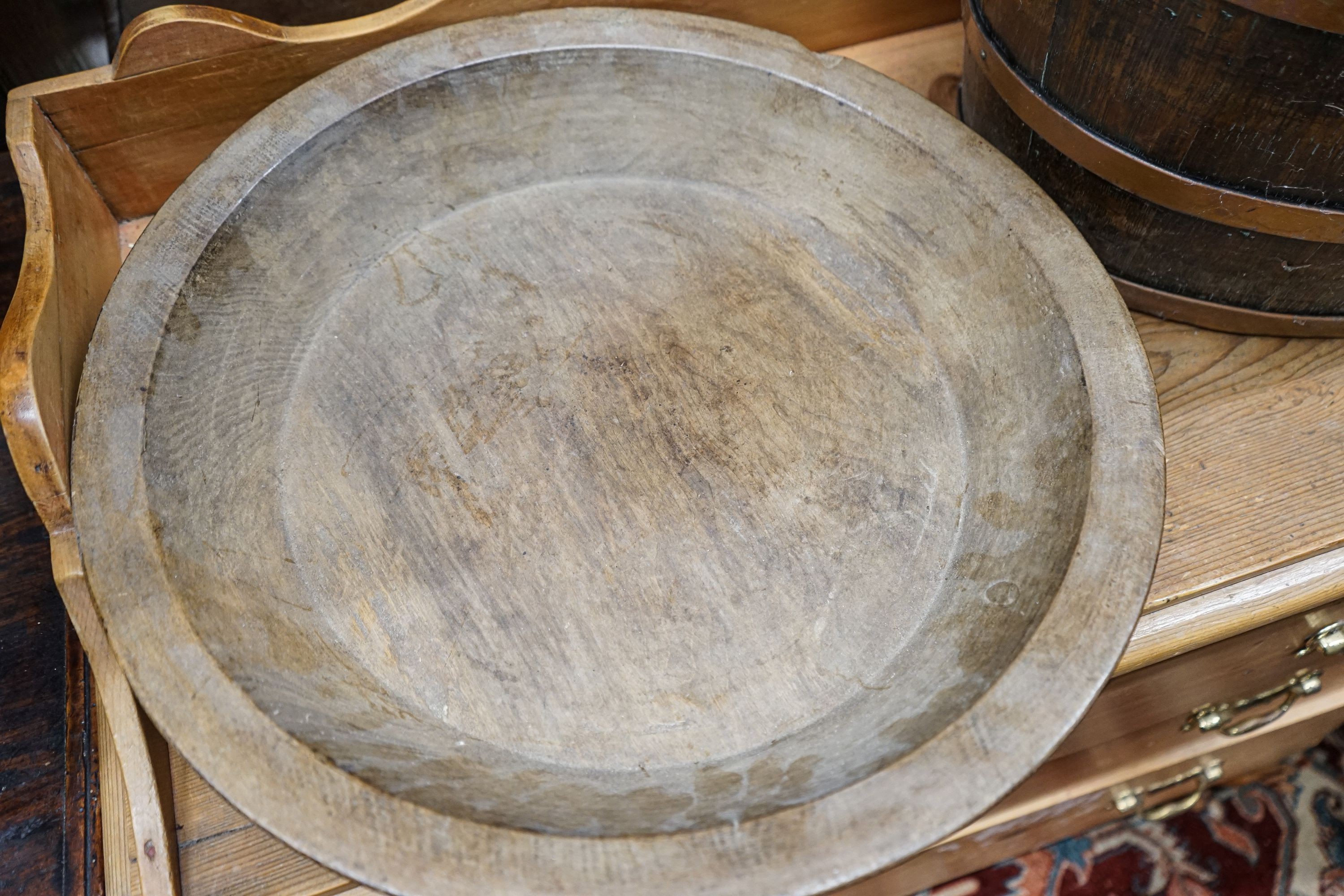 A copper bound staved oak log basket, width 45cm, depth 36cm, together with a circular turned beech bowl, 51cm